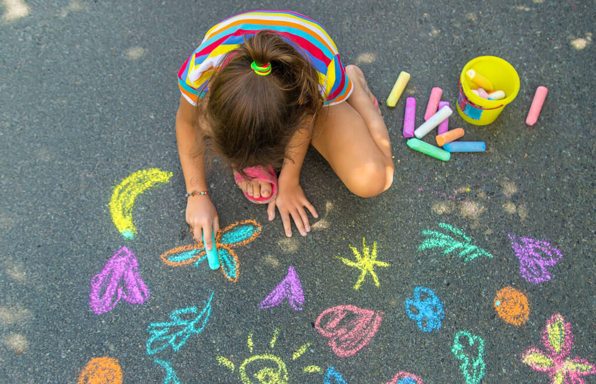 Petite fille créative qui dessine au sol